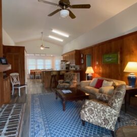 Cozy living room with fireplace and TV. Plus ceiling fans.